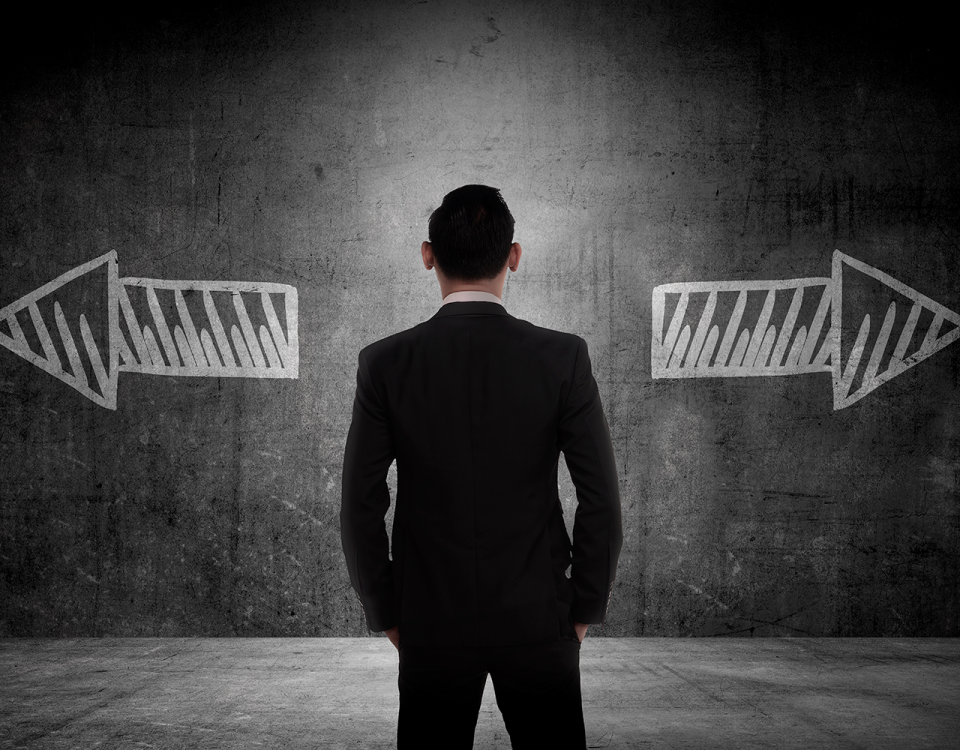 man standing in front of two opposite facing arrows