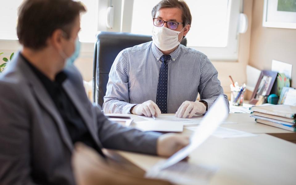 Financial planning and investments with clients wearing masks during the pandemic